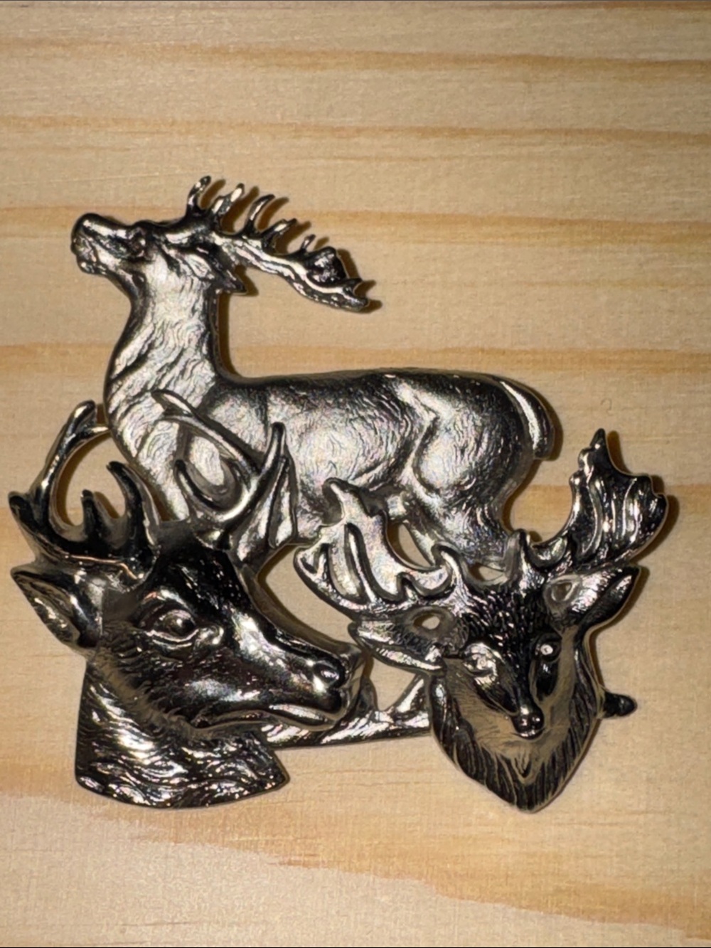 Vintage silver-tone metal brooch featuring a sculptural group of stags